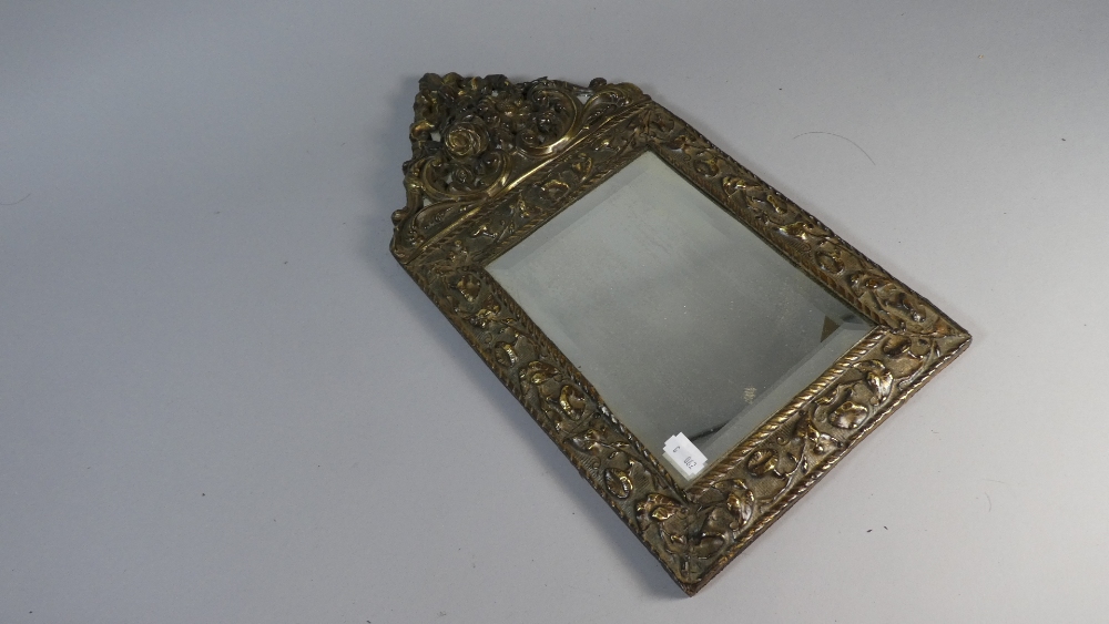 An Embossed Brass Frame Rectangular Wall Mirror with Bevelled Glass,