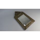 An Embossed Brass Frame Rectangular Wall Mirror with Bevelled Glass,