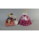 A Royal Doulton Figure, Victoria HN.2471 Together with a Figure Group The Bedtime Story HN.2059