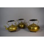 A Collection of Three Brass Kettles with Turned Wooden Handles