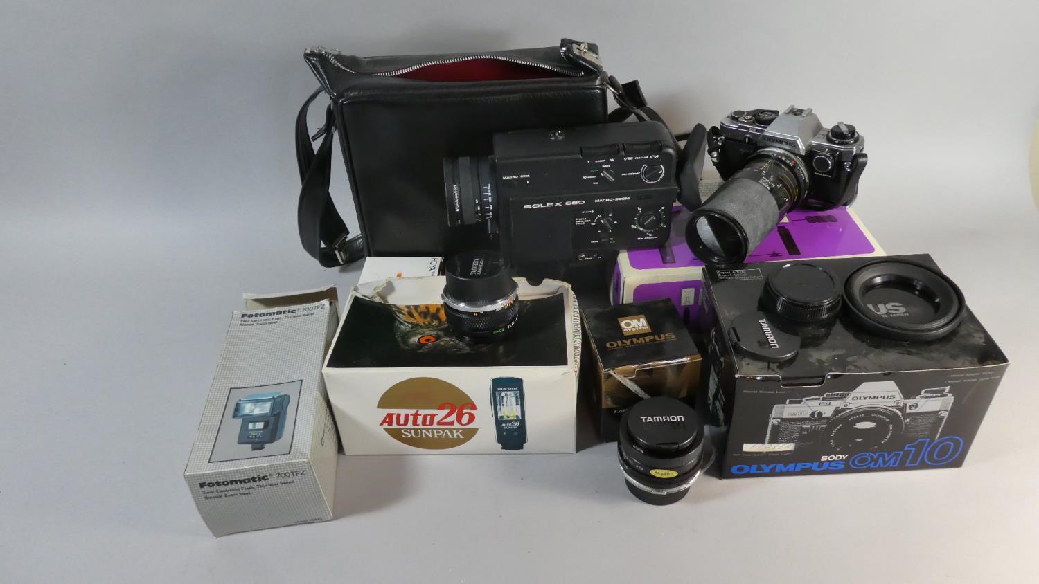 A Collection of Photographic Cameras and Sundries to Include Olympus 35mm Camera, Various Lenses,