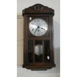 An Edwardian Oak Wall Clock with Westminster Chime Movement