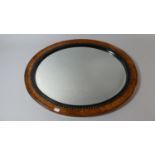 An Oval Wall Mirror, 59cm Wide