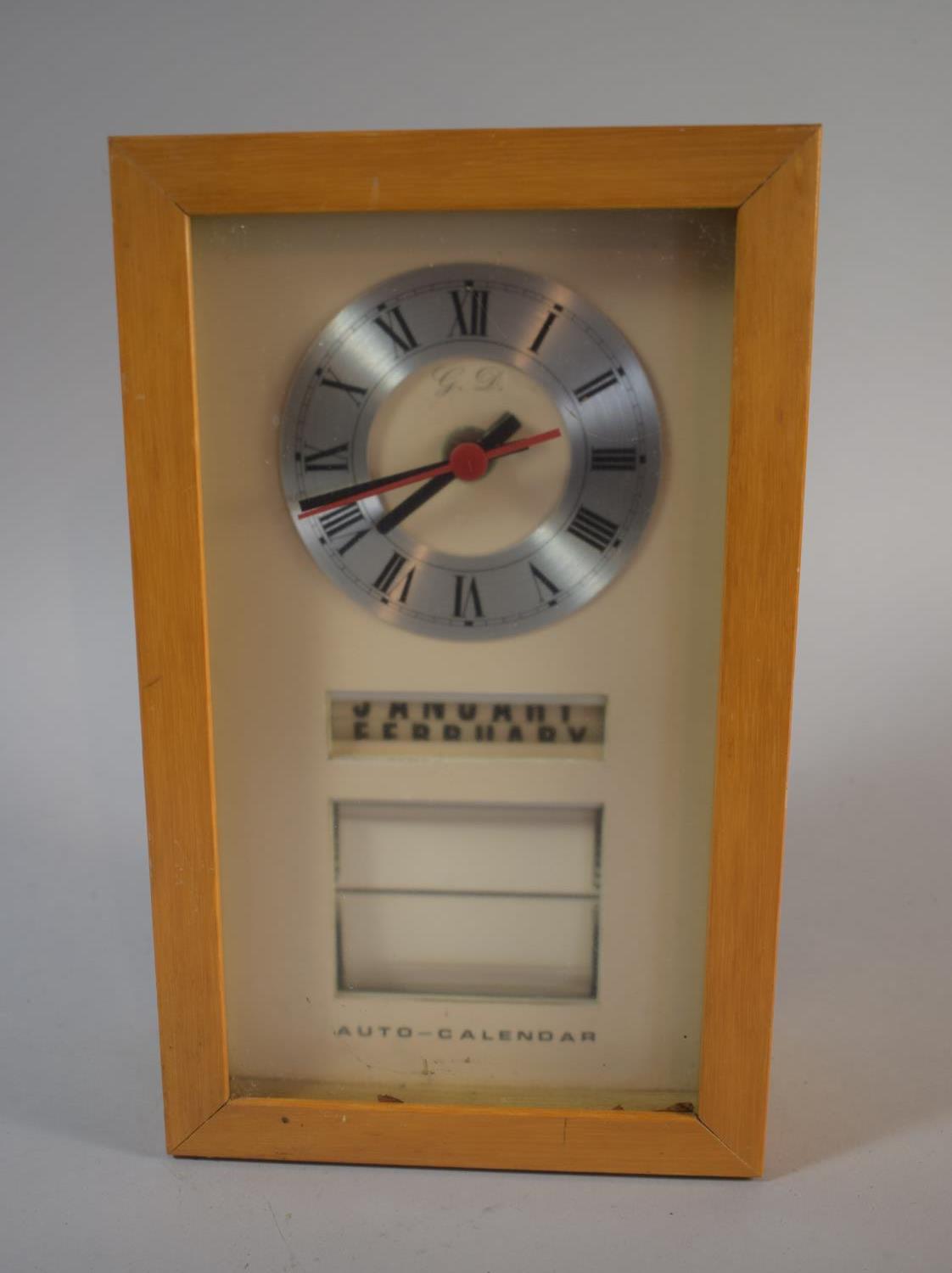 A 1970's Wall Mounting Clock and Auto Calendar with Battery Movement, 29cm High