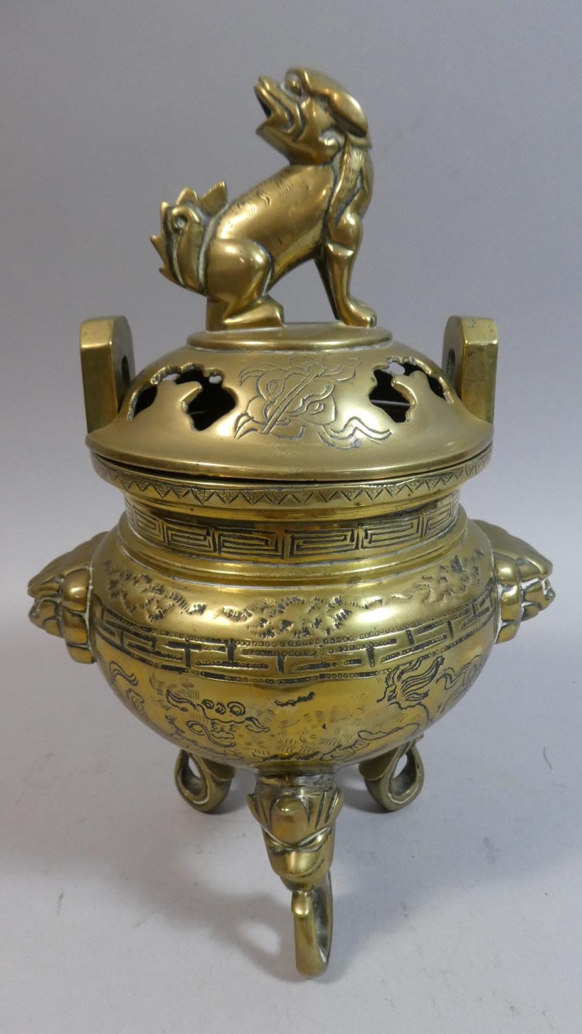 An Oriental Bronze Two Handled Censer with Pierced Lid, Lion Masks and Three Scrolled Mask Feet.