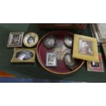 A Circular Tray Containing Miniature Prints and Photographs