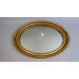 A Gilt Framed Wall Oval Wall Mirror, 46cm High