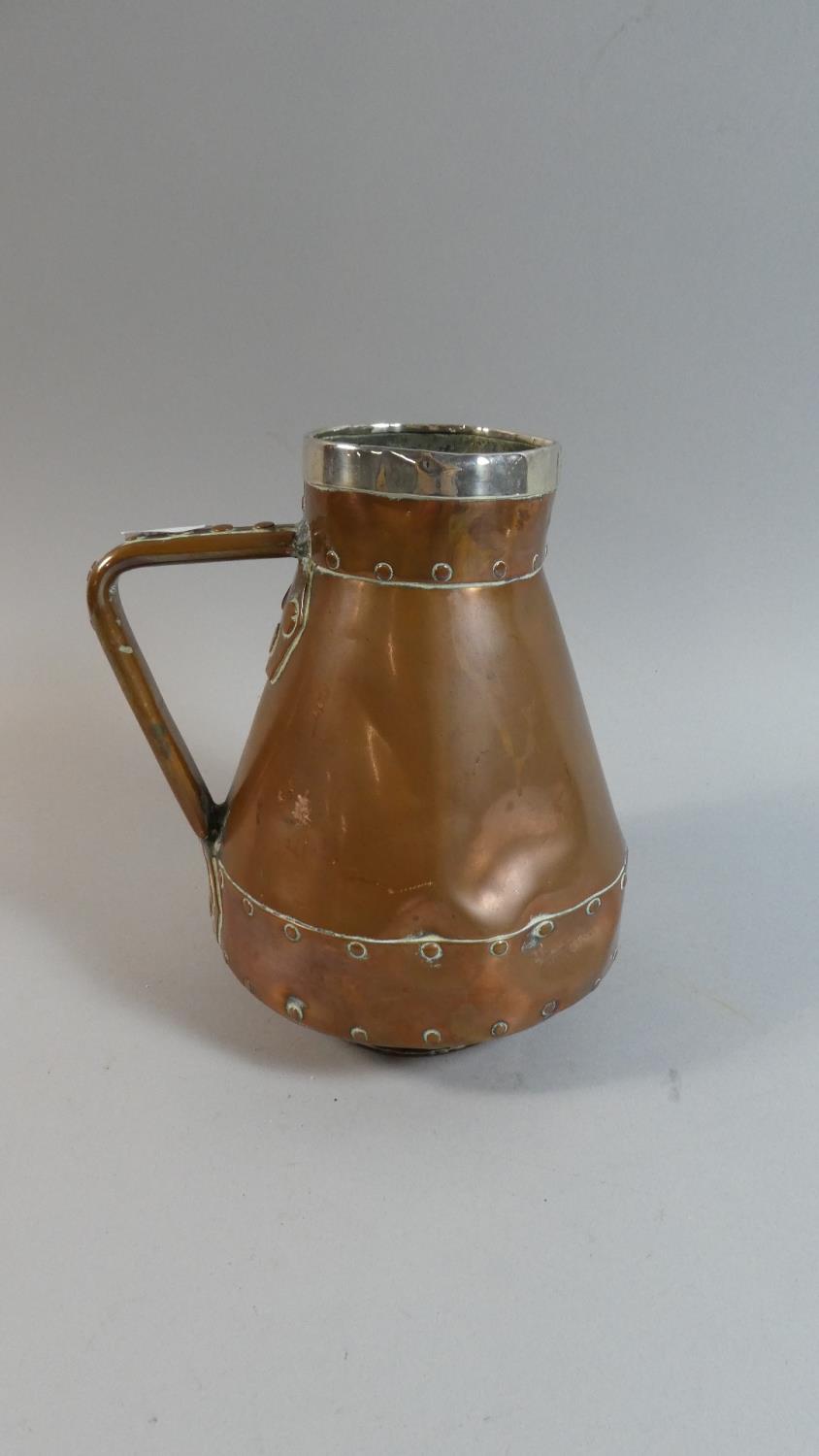 A Hand Beaten Silver Rimmed Copper Jug in the Arts and Crafts Style, 17.5cm High