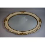 A Cream and Gilt Oval Wall Mirror, 60cm Wide