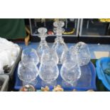 A Set of Six Cut Glass Brandy Balloons, Two Decanters and a Basket