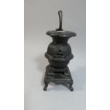 A Cast Iron Model of a Pot Bellied Stove, 20cm High