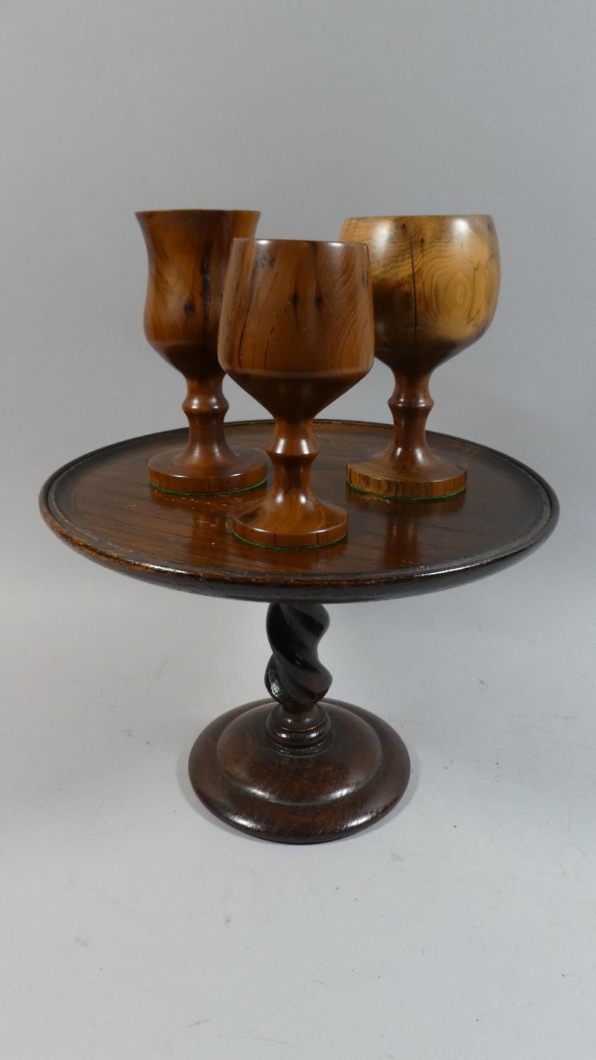 An Oak Circular Topped Tazza on Barley Twist Support, 26cm Diameter Together with Three Wooden