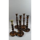 A Collection of Two Pairs of Oak Barley Twist Candle Sticks and Two Other Examples