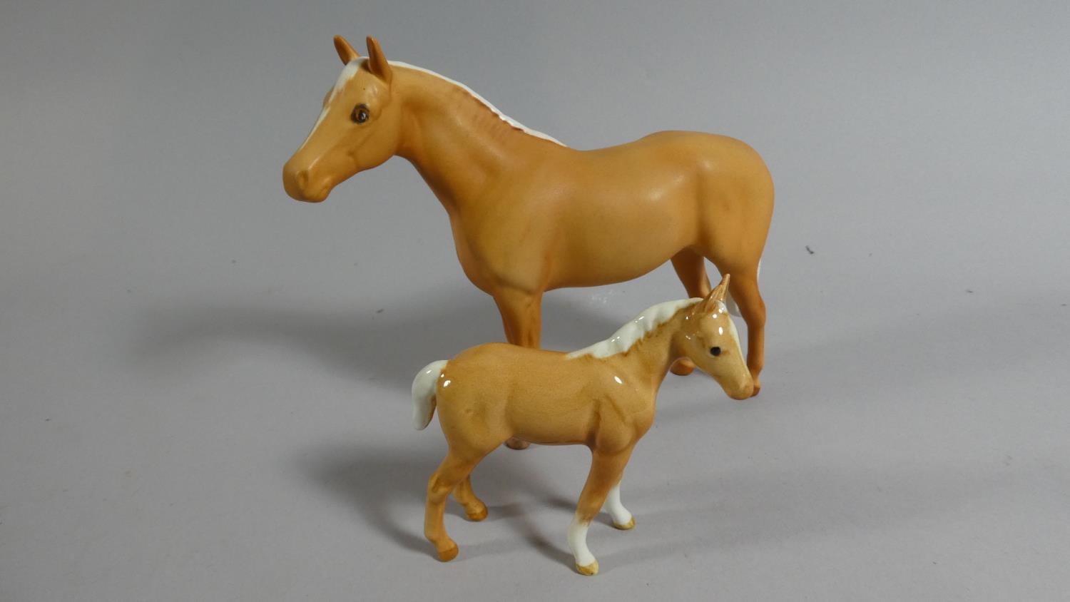 A Beswick Palomino Mare and Foal Ornaments
