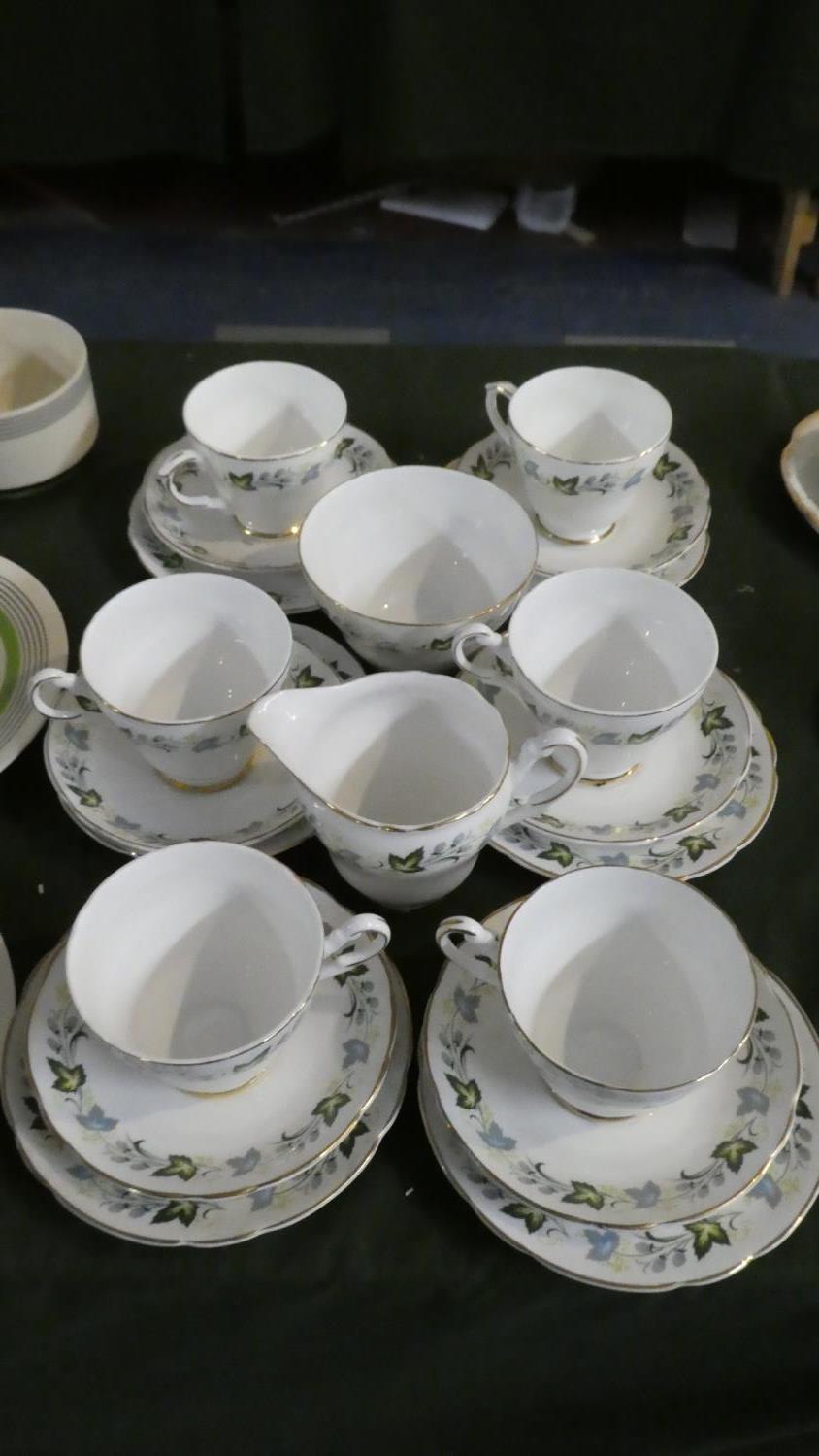 A Leaf Pattern Tea Set Comprising Six Trios, Sugar and Cream