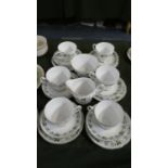 A Leaf Pattern Tea Set Comprising Six Trios, Sugar and Cream