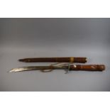 A Far Eastern Carved Teak Sword and Scabbard