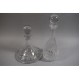 A Cut Glass Ships Decanter and a Globe and Stalk Decanter