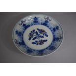 An Oriental Blue and White Bowl decorated with Flowers and Stylised Bats, 20cm Diameter.