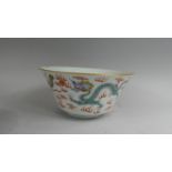 A Chinese Bowl decorated in Multicoloured Enamels depicting Dragons Chasing Flaming Pearls. Chip