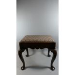 A Georgian Style Oak Stool with an Upholstered Seat over a Shaped Frieze. Supported on Cabriole