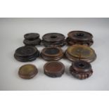 A Collection of Nine Oriental Carved Wooden Circular Stands