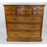 A Victorian Walnut Chest by Maple and Co having Two Small Drawers Flanking Deep Top Drawer and Three