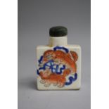 A Chinese Snuff Bottle of Flattened Square Form decorated with Orange and Blue Enamels depicting Foo