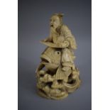 A Signed 19th Century Chinese Ivory Okimono of Elder with Scroll Riding Carp. 15cms High