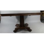 A Victorian Rectangular Snap Top Mahogany Breakfast Table on Reeded Column Support with Quadrant