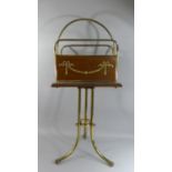 An Edwardian Brass and Mahogany Raised Magazine Rack with Adam Style Swag Decoration. 74cms High