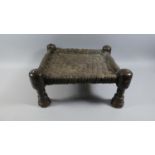 A 19th Century Indian Carved Wooden Stool with a Woven Leather Seat. 42x40x20cms