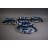 A Set of Four Chinese Blue and White Sauce Boats on Trays decorated with Pagodas and Willow Trees.