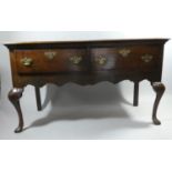A 19th Century Oak Two Drawer Dresser Base with Pierced Brass Drop Handles and Escutcheons, Shaped