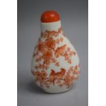 A Chinese Ceramic Snuff Bottle of Pear Shape decorated with Orange Enamels depicting Birds in