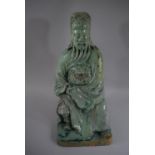 An Early Glazed Chinese Stoneware Figure of Seated Immortal Wearing Robe with Lion Mask Decoration