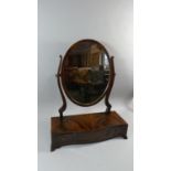 A Mahogany Swing Toilet Mirror with Oval Glass and Serpentine Plinth Base, Having one Long and two