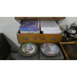 A Vintage Suitcase Containing Various Decorated Plates
