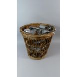 A Vintage Wicker Waste Bin Containing Shoe Trees