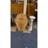 A Wicker Alibaba Laundry Basket and Ceramic Jardiniere Stand