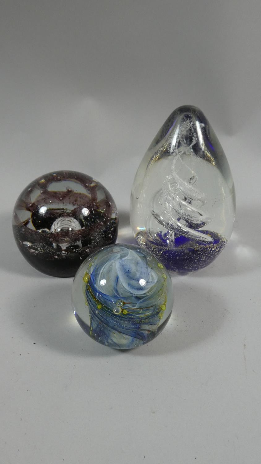 A Collection of Three Glass Paperweights to Include Caithness