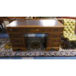 A Kneehole Writing Desk with Tooled Leather Top Having Centre Long Drawer Flanked by Two Banks of