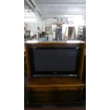 A Modern Walnut Veneered TV Cabinet with Panasonic 37" Screen on Retractable Swivel Mount, the
