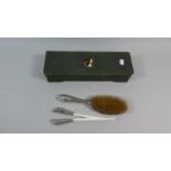 An Art Nouveau Glove Box Containing Silver Mounted Glove Stretchers and Silver Plated Hairbrush