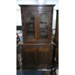 A Late Victorian Oak Library Bookcase with Carved Mounts, the Base with Long Drawer Over Panel Doors