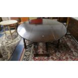 A Good Quality Reproduction Oak Drop Leaf Oval Topped Gate Leg Wake Table with Turned Supports,