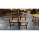 A Pair of Rush Seated Ladder Back Dining Chairs to Include One Carver