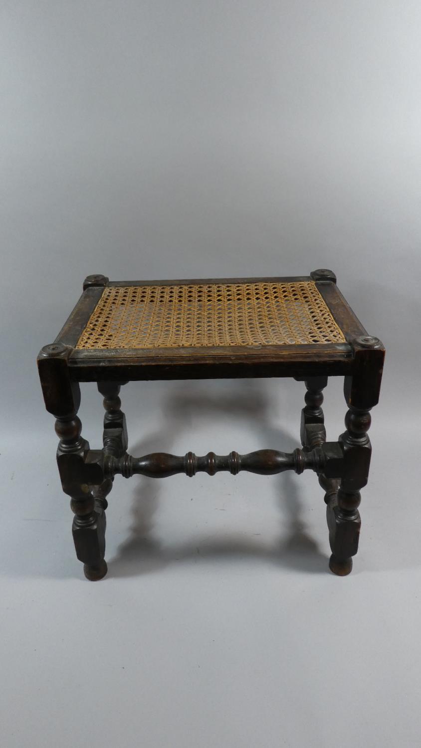 An Edwardian Oak Framed Cane Seated Rectangular Topped Stool, 41cm Wide