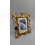 A Reproduction Gilt Framed Easel Backed Photo Frame with Pierced Border