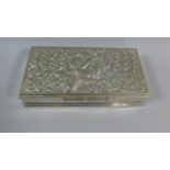 A White Metal Far Eastern Rectangular Box with Hinged Lid Decorated in Relief with Dancing